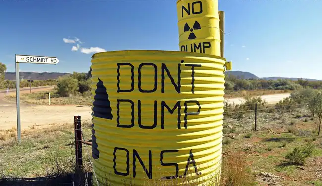 large dumps painted with dont dump on SA by an arid dirt road