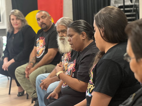 Barngarla traditional owners sitting in a row. They are talking to an audience.