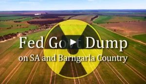 Nuclear symbol on top of drone footage of Kimba farm land - the site for the waste dump. Text reads "Fed Govt Dump on SA and Barngarla Country"